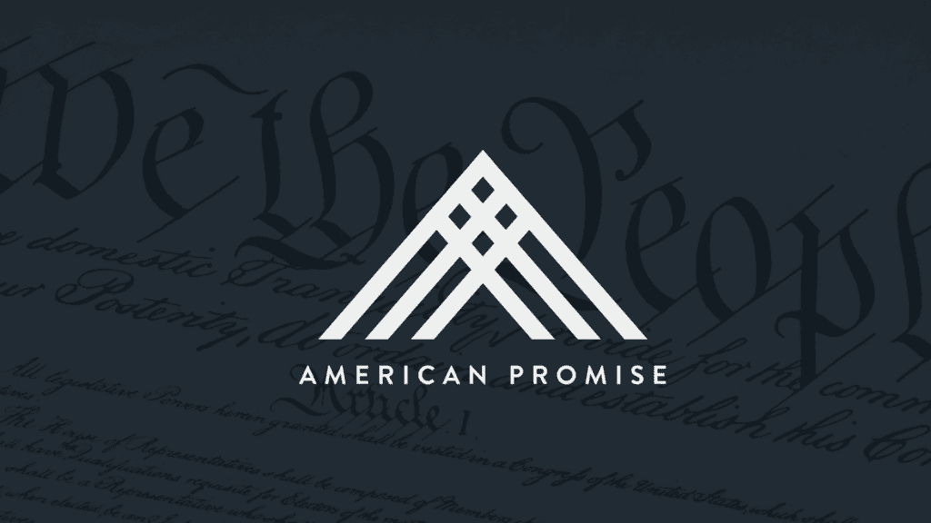 The American Promise logo in white on the Constitution. The logo contains three interlocking triangles.